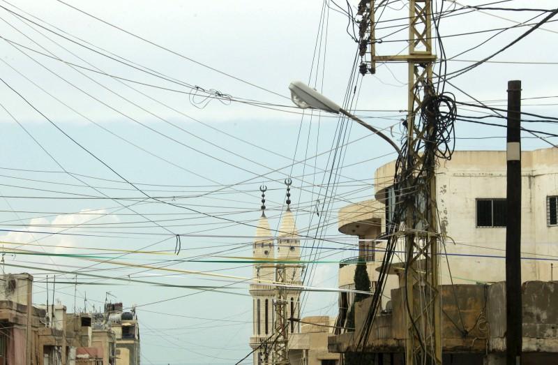 Power cables erected in a chaotic way are pictured at a residential area of Sibline village, in the Chouf area, Mount Lebanon